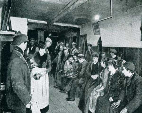 People in the kitchen of a common lodging house.