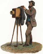 A bearded man stands with a Victorian style camera..