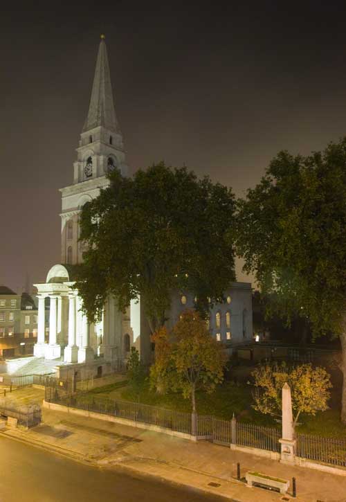 The white tower and spire of Christchurch, Spitalfields seen by night.