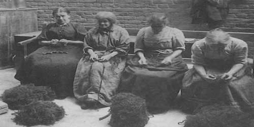 A group of Victorian women picking oakum.