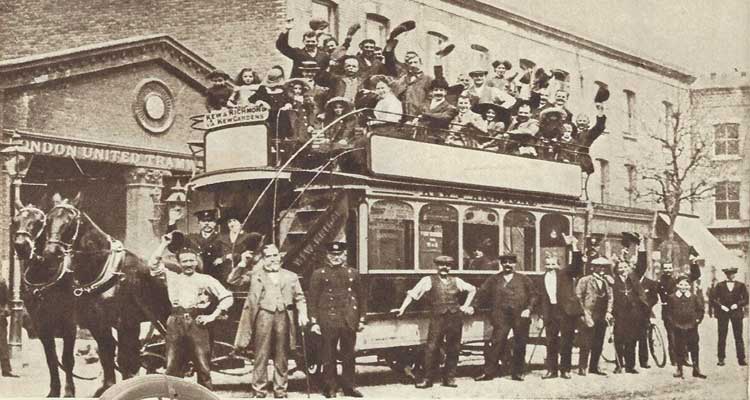People on a Victorian horse-drawn bus.