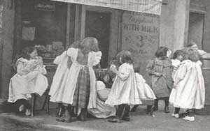 Children gathered arounda shop having a picnic.